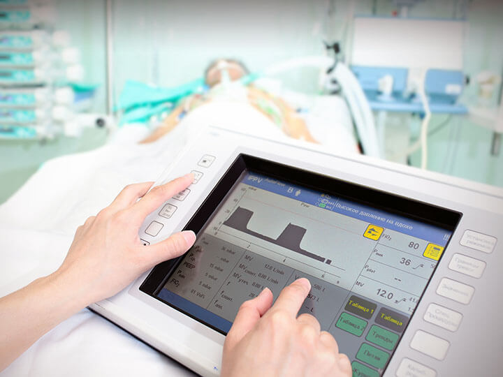 Hands operating a medical terminal